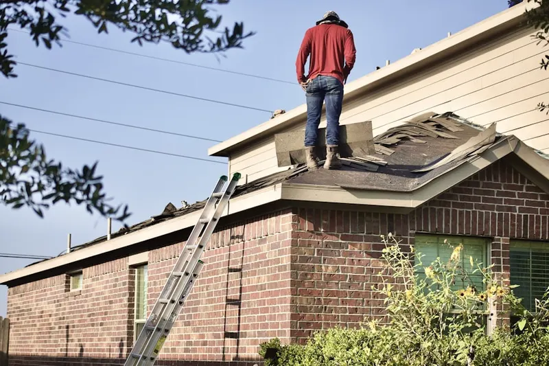 Professional roofer working on a residential roof in New Suffolk